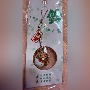 New Hello Kitty Gold Round Bell Charm features delightful sakura design 💖